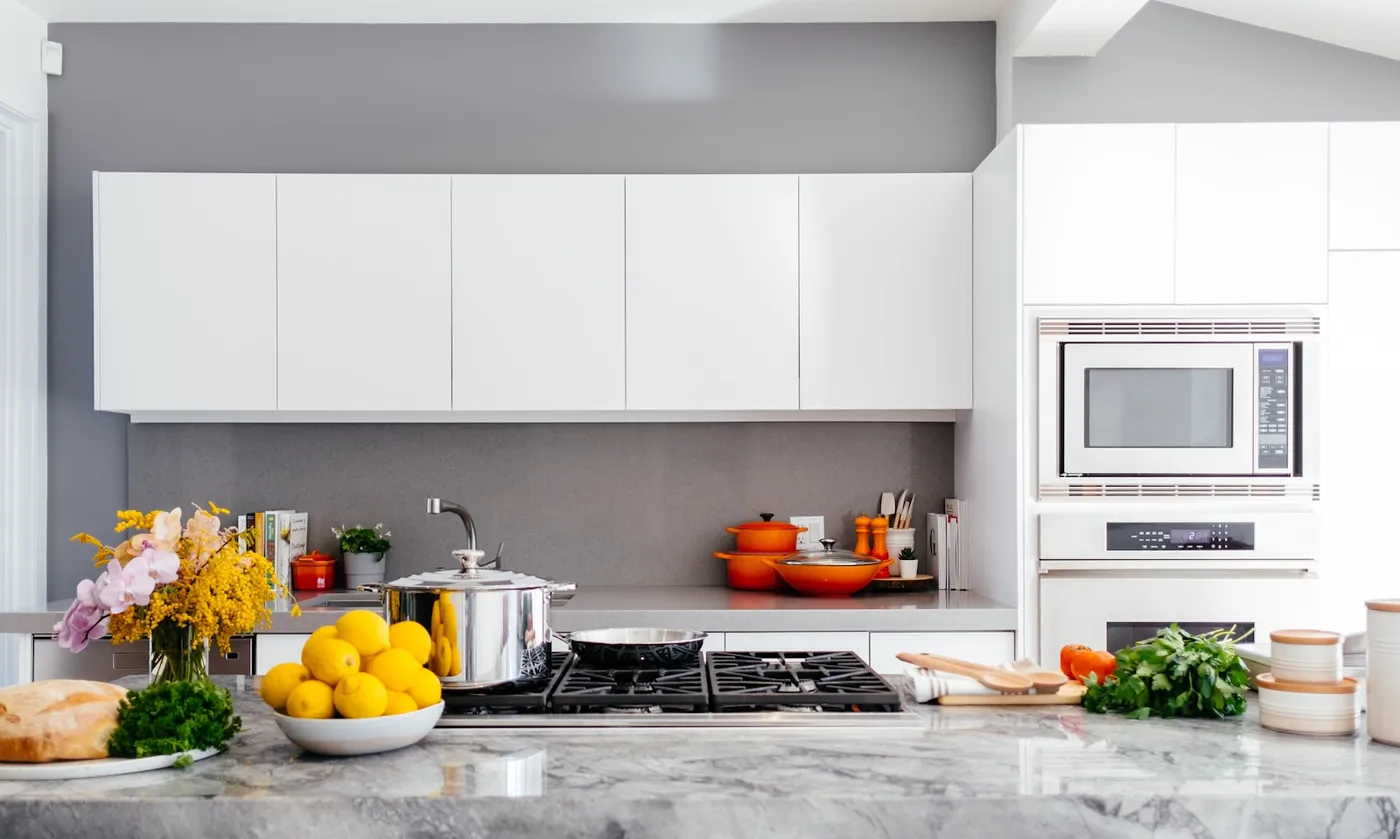 The remodeled kitchen: flat-panel cabinetry, stone counters, and built-in ovens