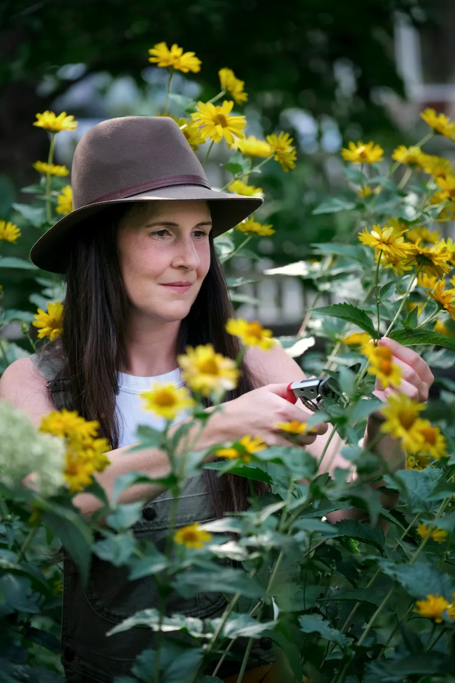 Saskia Lund working through a planting bed with pruners