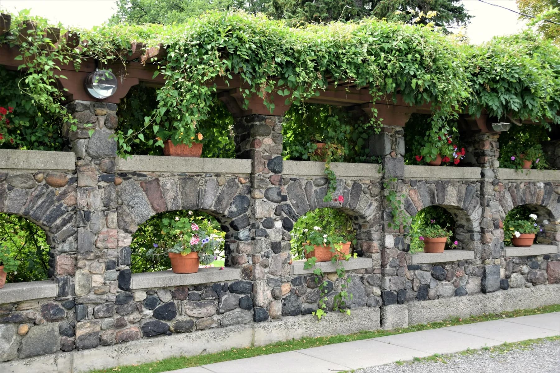 The lower dry-stone wall softened by lichen and ferns