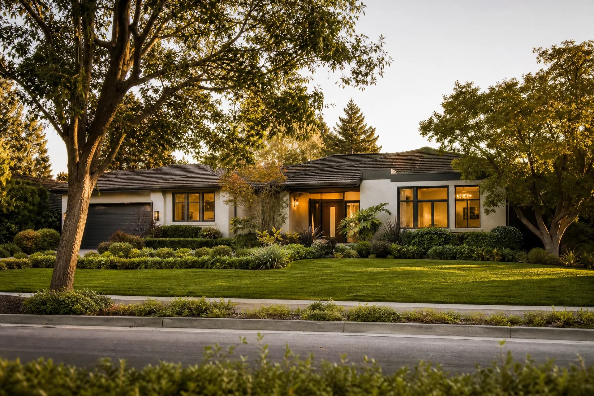 A well-kept single-family home on a quiet, tree-lined South Bay street at golden hour
